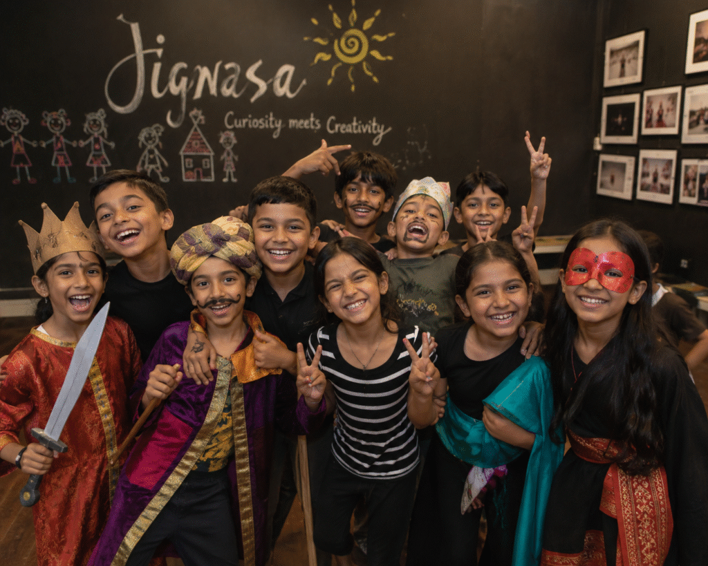 children smiling in costumes after a theatre performance at Jignasa activity centre in Nallagandla.